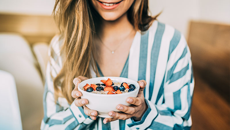 Woman choosing to eat a healthier breakfast in the morning