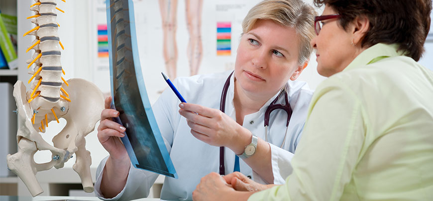 Chiropractor discussing x-ray results with patient