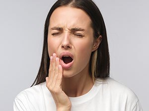 Woman suffering from TMJ pain