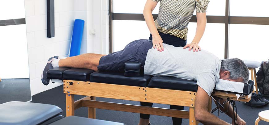 Patient getting drop technique treatment for back pain relief